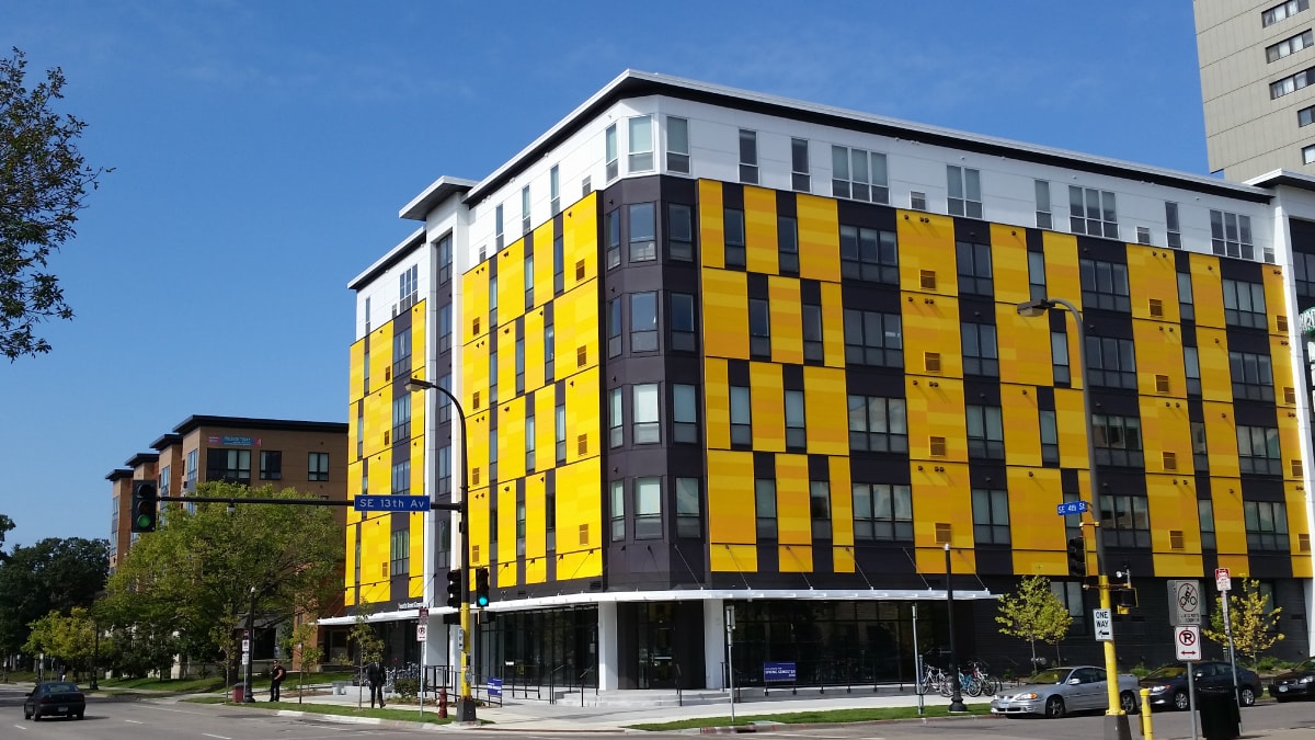 large modern yellow and white apartment building