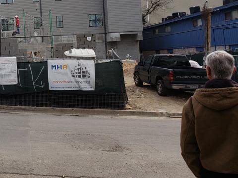 A photograph of ICC Austin's newest cooperative under construction in 2019 being viewed by a previous Director of ICC Austin, Jim Jones