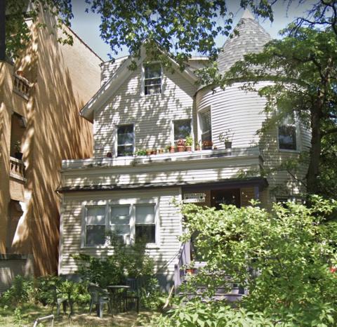 Haymarket House, a two-story white house with a purple porch and large green yard